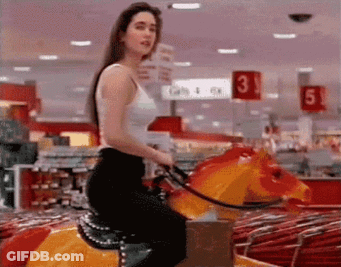 Woman Riding Rocking Horse In Store With Number 3 GIF