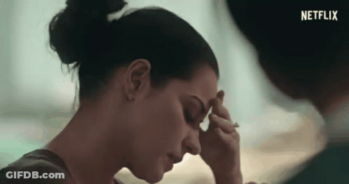 Woman Rubbing Forehead Man Looking On Netflix Ad GIF