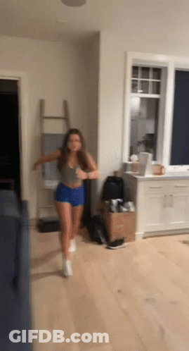 Woman Running In Living Room In Front Of Window GIF