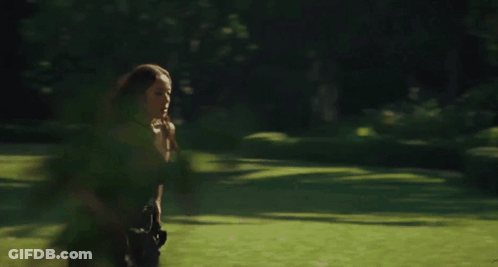 Woman Running Through Field Of Greenery GIF