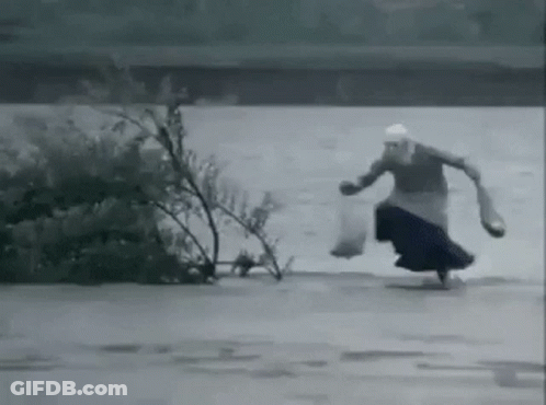 Woman Running Through Flooded Area GIF