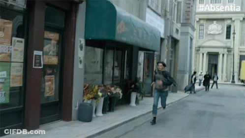Woman Running With #Absentia Sign GIF