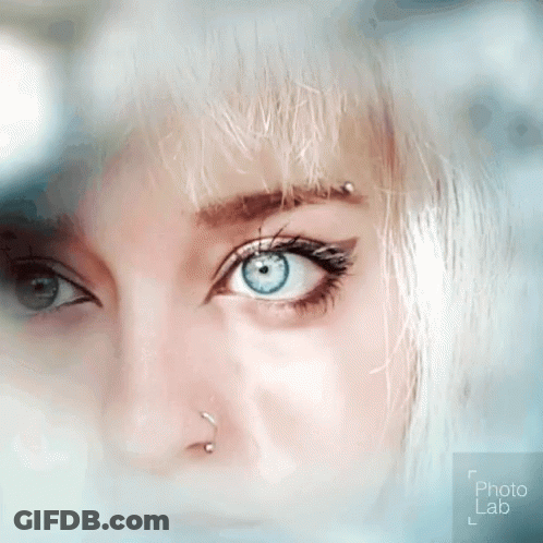 Woman's Blue Eye With Nose Ring And Piercing GIF