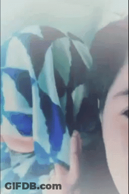 Woman's Face Close Up With Blue And White Shirt Pattern GIF