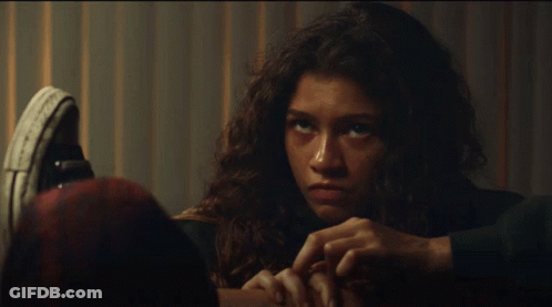 Woman's Face Close-Up With Converse Shoe GIF