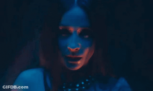 Woman's Face In Dark Room With Red And Blue Lights GIF
