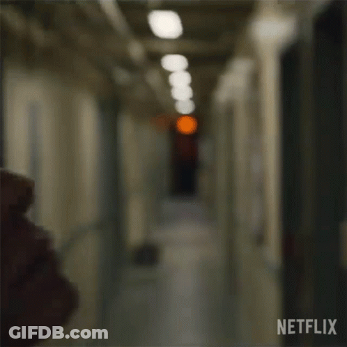 Woman's Face In Hallway With Red Light GIF