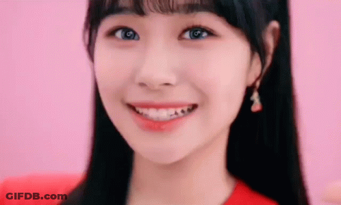 Woman's Face On Pink Background In Red Shirt GIF