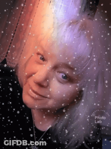 Woman's Face Surrounded By Snowflakes GIF