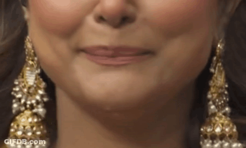 Woman's Face Wearing Gold And Pearl Earrings GIF