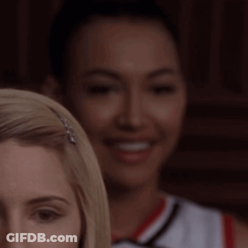 Woman's Face With Cheerleader Behind GIF
