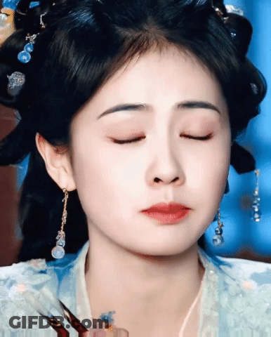 Woman's Face With Earrings And Eyes Closed GIF