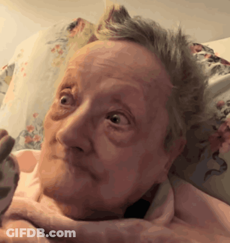 Woman's Face With Pink Blanket GIF