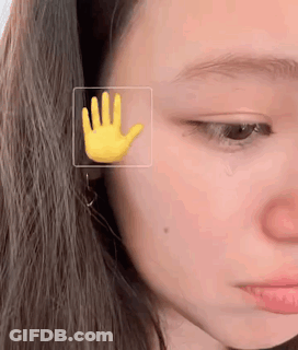Woman's Face With Yellow Hand GIF