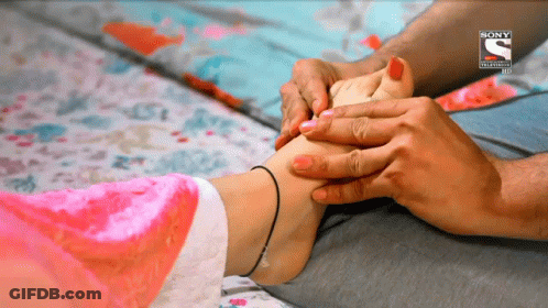 Woman's Foot Massaged By Man In Front Of Sony Advertisement GIF