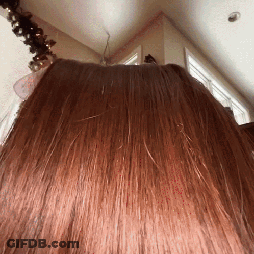 Woman's Hair Close Up With Christmas Tree GIF