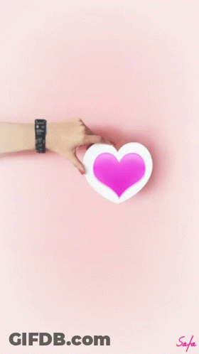Woman's Hand Holding Pink Heart GIF