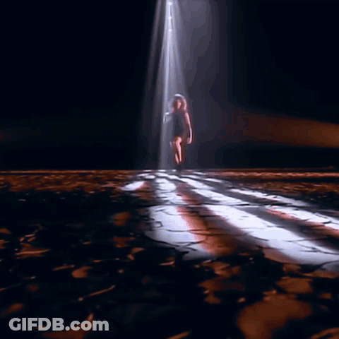 Woman's Legs In Black Boots On Wooden Floor GIF
