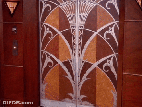 Woman Saying Enjoy The Day In Front Of Door GIF