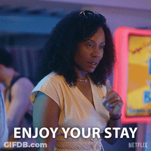 Woman Saying Enjoy Your Stay By Neon Sign GIF