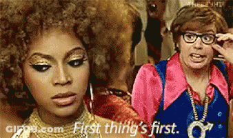 Woman Saying First Thing's First Beside Man With Glasses GIF