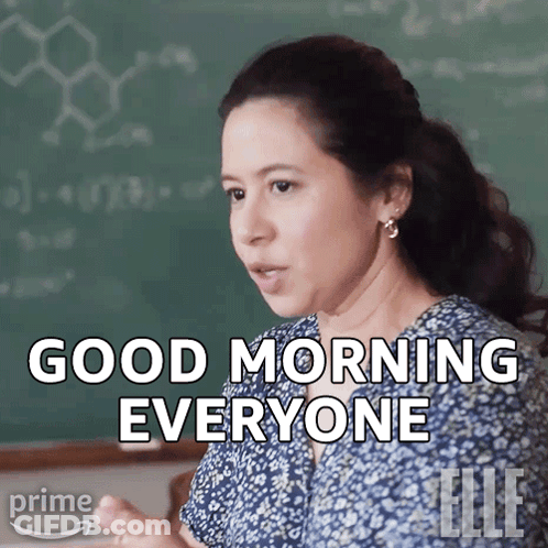 Woman Saying Good Morning Everyone In Front Of Blackboard GIF
