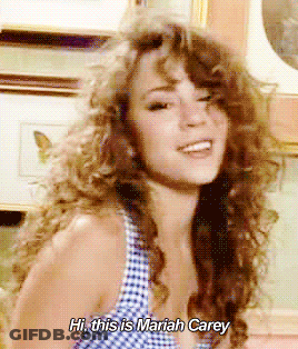 Woman Saying Hi This Is Mariah Carey In Front Of Picture GIF