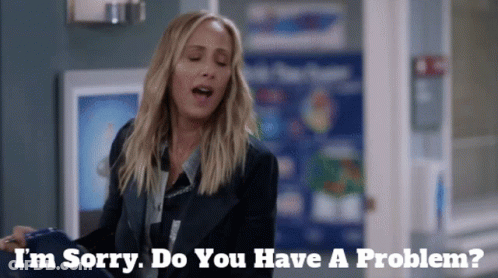 Woman Saying I'm Sorry Do You Have A Problem In Front Of Sign GIF