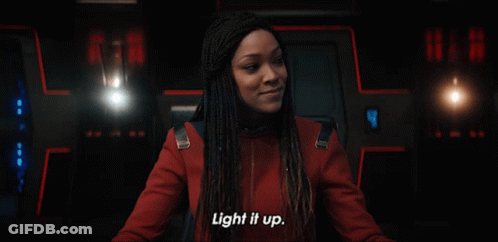Woman Saying Light It Up In Dark Room GIF