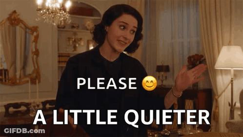 Woman Saying Please A Little Quieter In Front Of Chandelier GIF