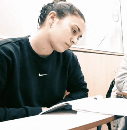 Woman Saying Um Okay In Front Of Shelves GIF