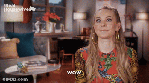 Woman Saying Wow In Front Of Real Housewives Sign GIF