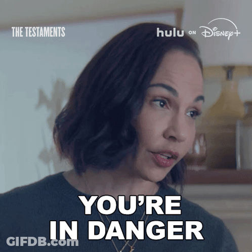 Woman Saying You're In Danger In Front Of Disney GIF