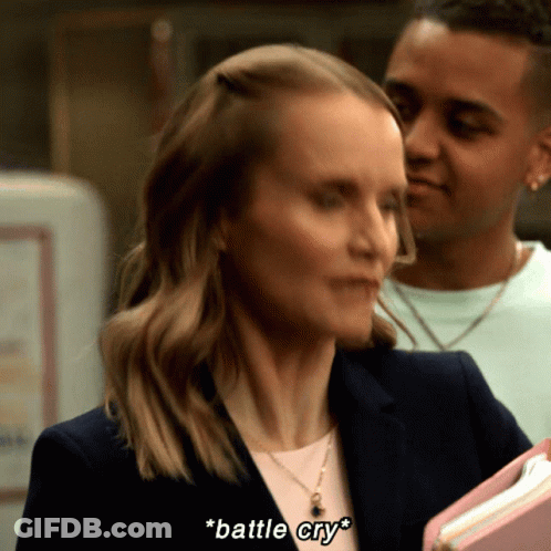 Woman Says Battle Cry While Holding Binder GIF