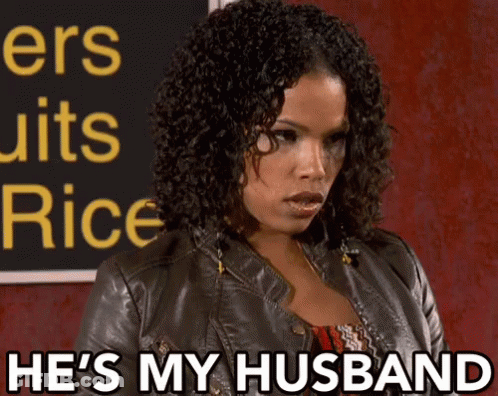 Woman Says He's My Husband In Front Of Sign GIF
