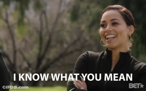 Woman Says I Know What You Mean In Front Of Trees GIF