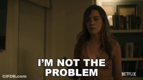 Woman Says I'm Not The Problem In Front Of Bookshelf GIF