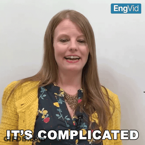 Woman Says It's Complicated In Yellow Cardigan GIF