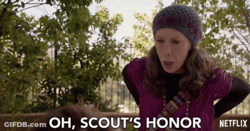 Woman Says Oh Scouts Honor In Front Of Fence GIF