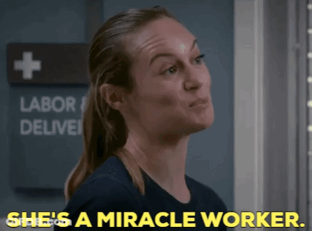 Woman Says She's A Miracle Worker In Front Of Labor Deliver Sign GIF
