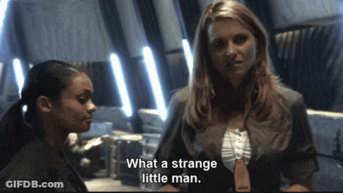 Woman Says What A Strange Little Man In Front Of Another Woman GIF