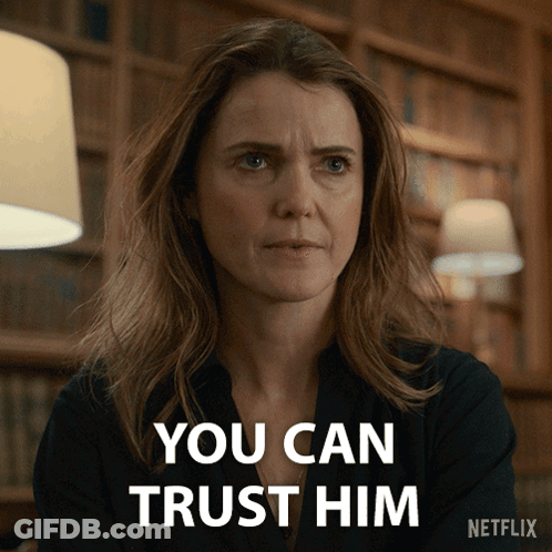 Woman Says You Can Trust Him In Front Of Bookshelf GIF