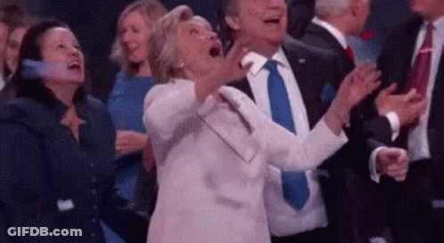 Woman Screaming In Crowd While Man In Suit Claps GIF