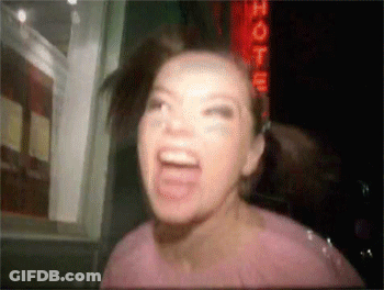 Woman Screaming In Front Of Hotel Sign GIF
