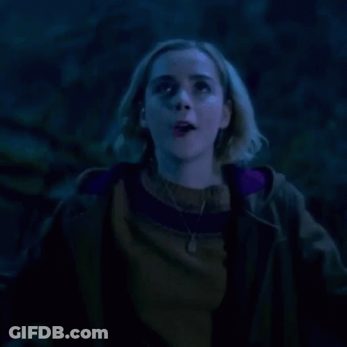 Woman Screaming With Mouth Open In Dark GIF
