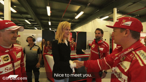 Woman Shaking Hands With Man In Red Santander Hat GIF