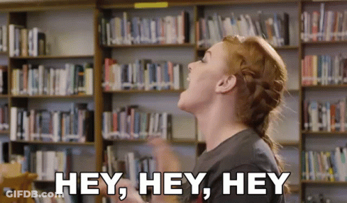Woman Shouting Hey In Library GIF