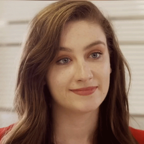 Woman Showing Awkward Smile Reaction GIF