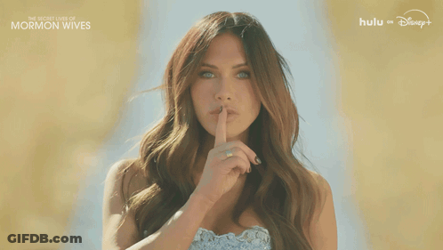 Woman Shushing Beside The Secret Lives Of Mormon Wives Sign GIF