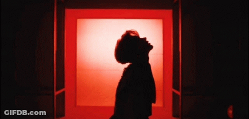 Woman Silhouette Looking Up At Sky In Red Room GIF